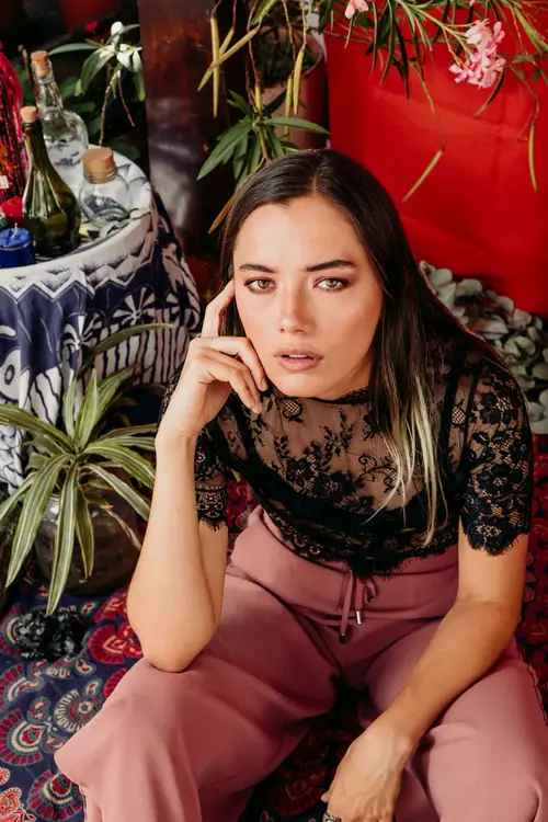 MYSTICA — full look against a red backdrop and textiles