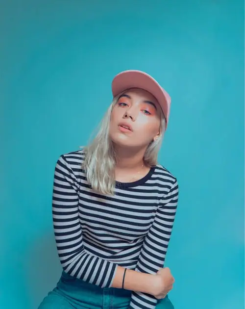 NITRATO — pink cap and stripes on teal backdrop